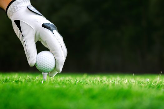 Hand Putting Golf Ball